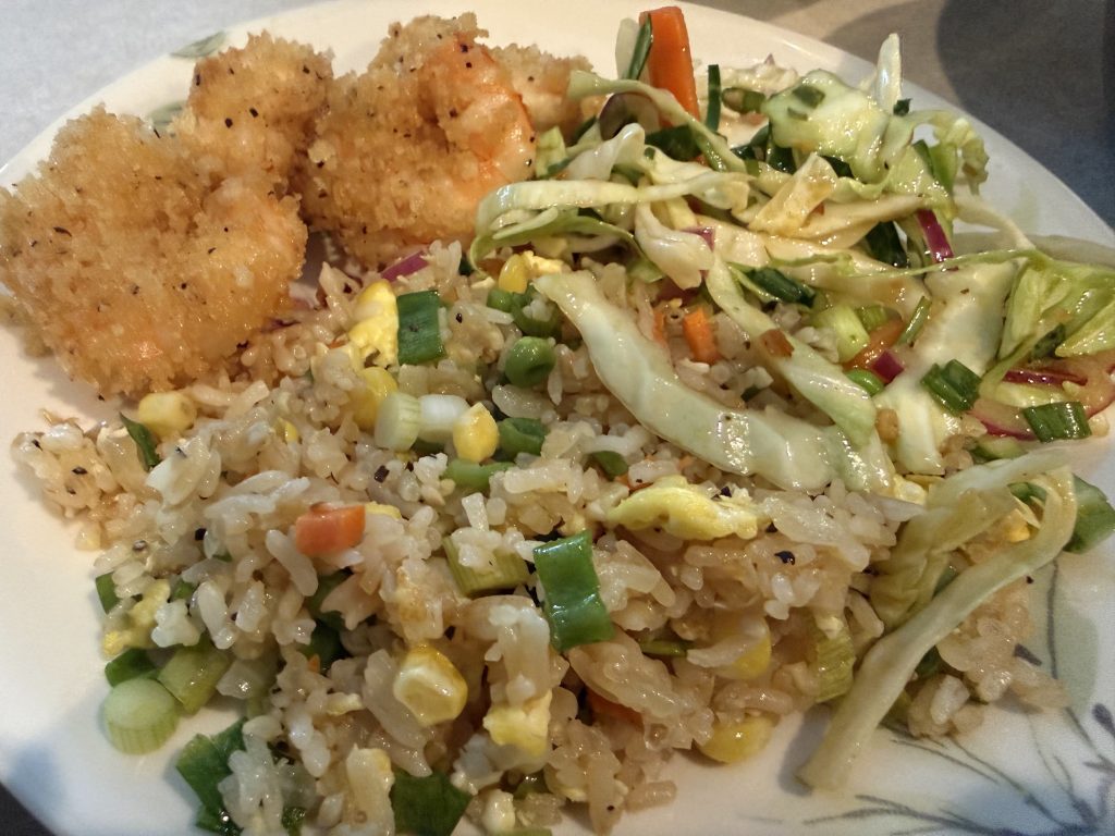 Plate of fried swordfish, homemade fried rice and Asian-style slaw.