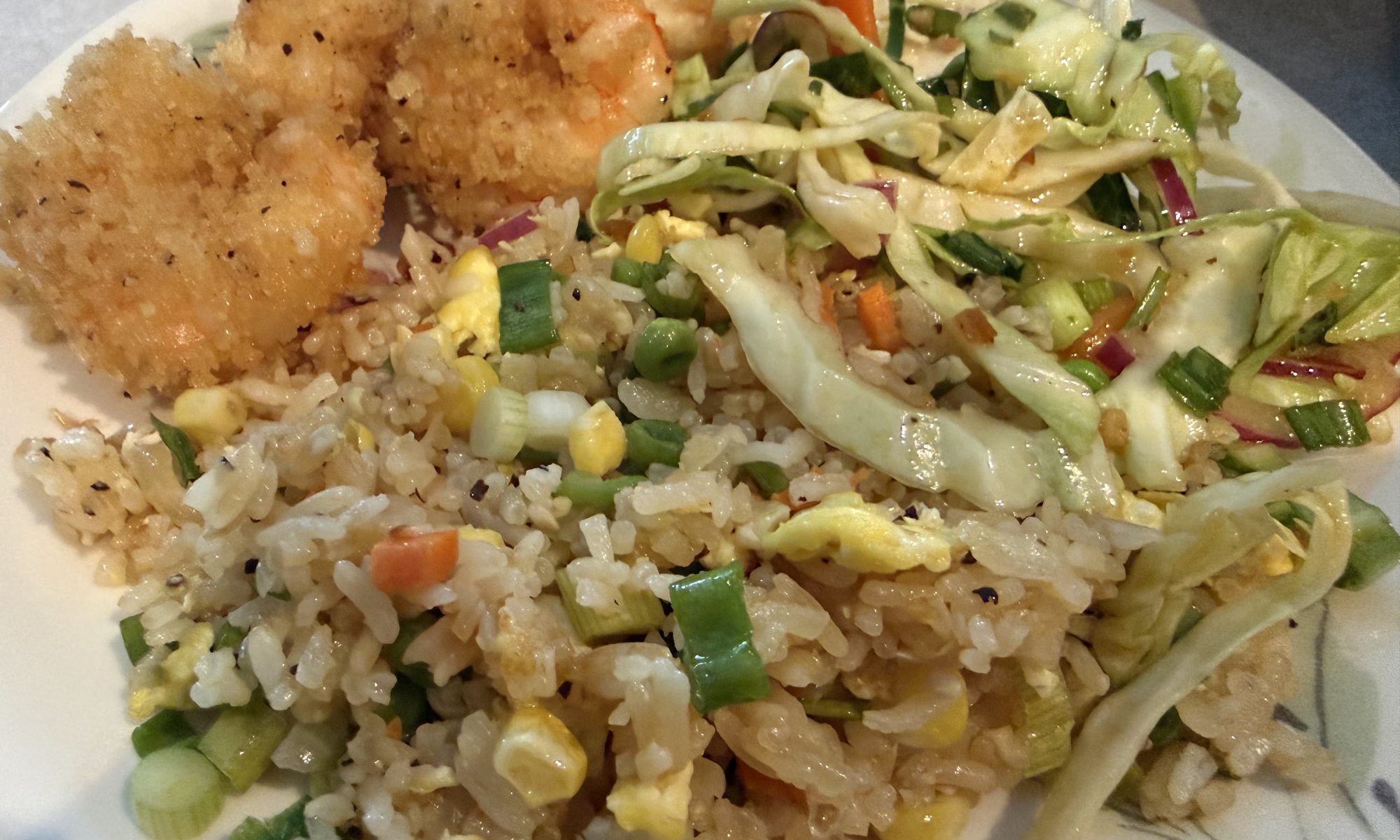Plate of fried swordfish, homemade fried rice and Asian-style slaw.