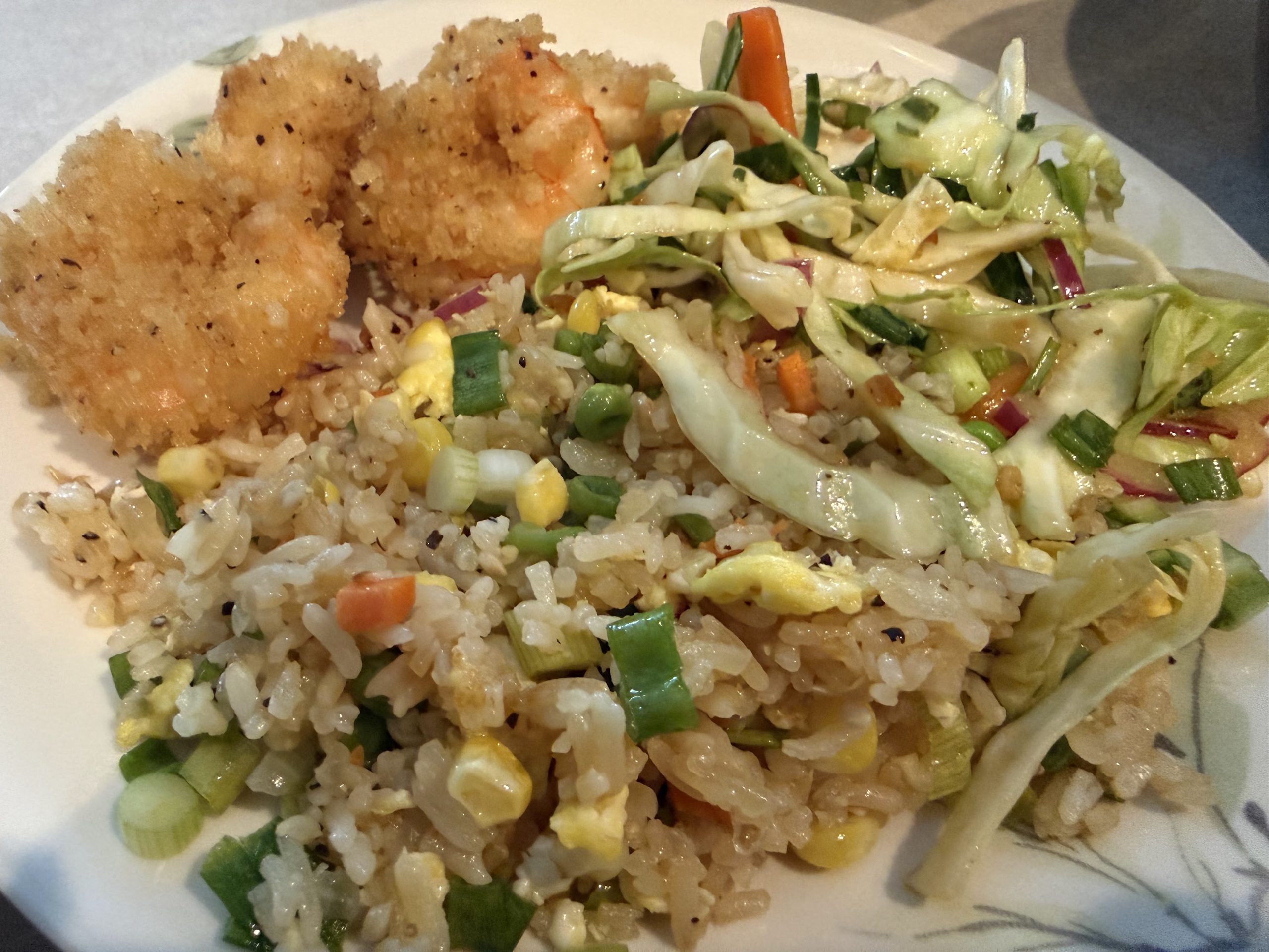 Plate of fried swordfish, homemade fried rice and Asian-style slaw.