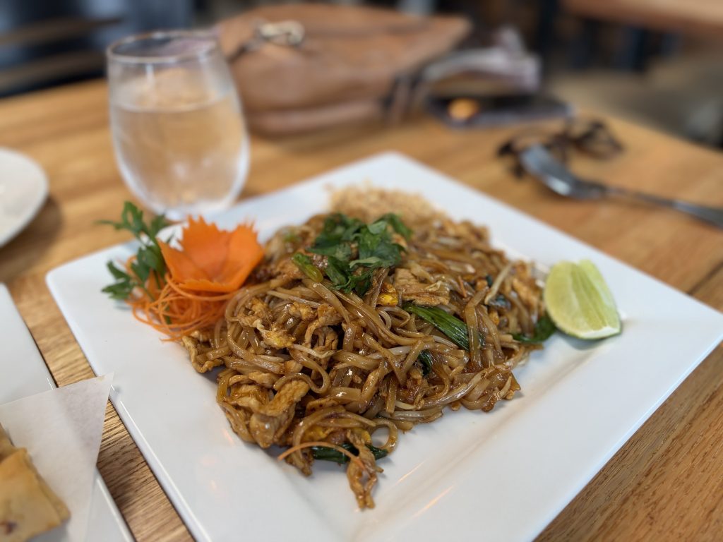Chicken Pad Thai with lime and fresh garnish at Hoang Khao