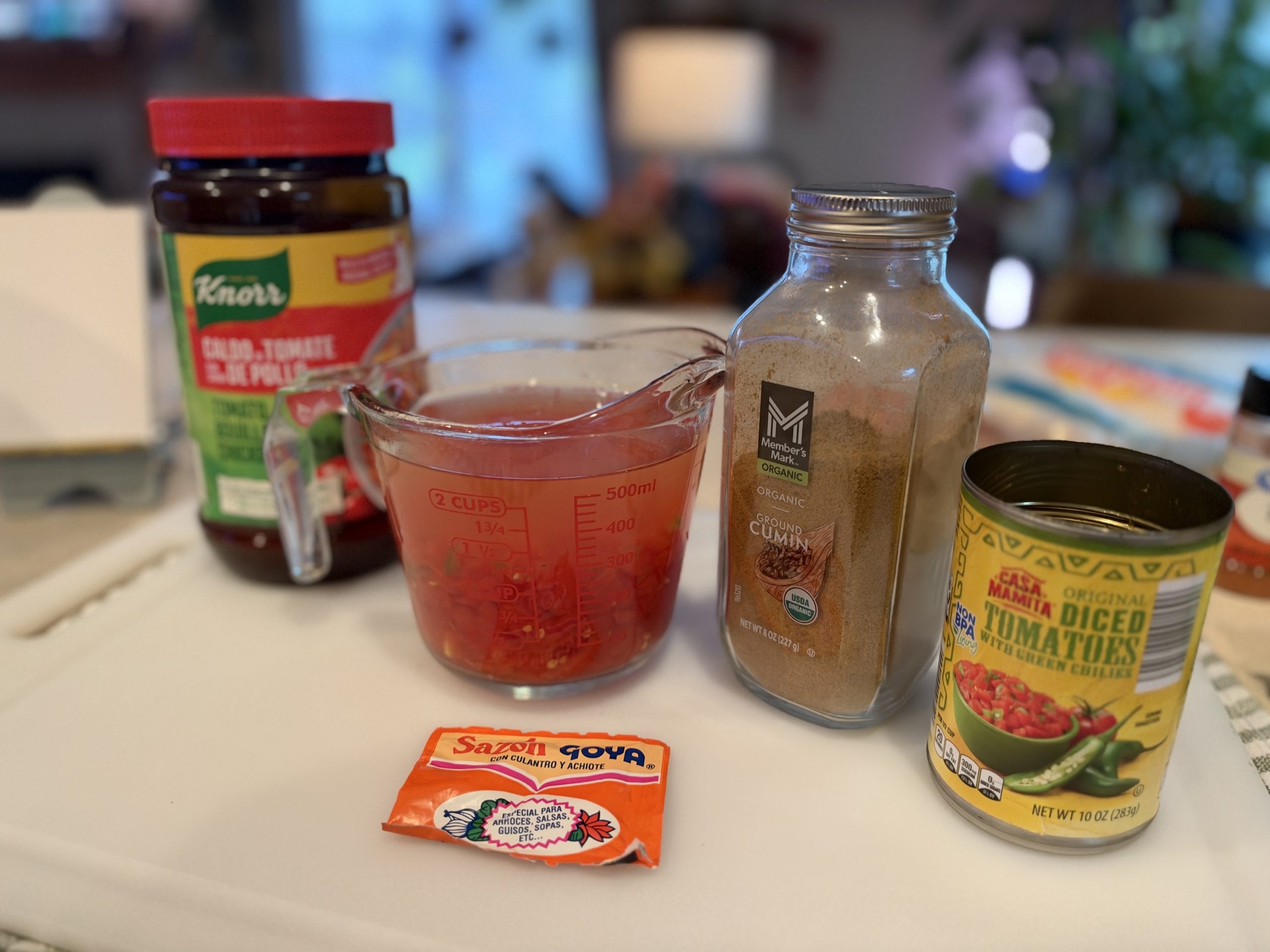 Tomato bouillon, Sazón, cumin, diced tomatoes and tomato liquid ready for Spanish rice