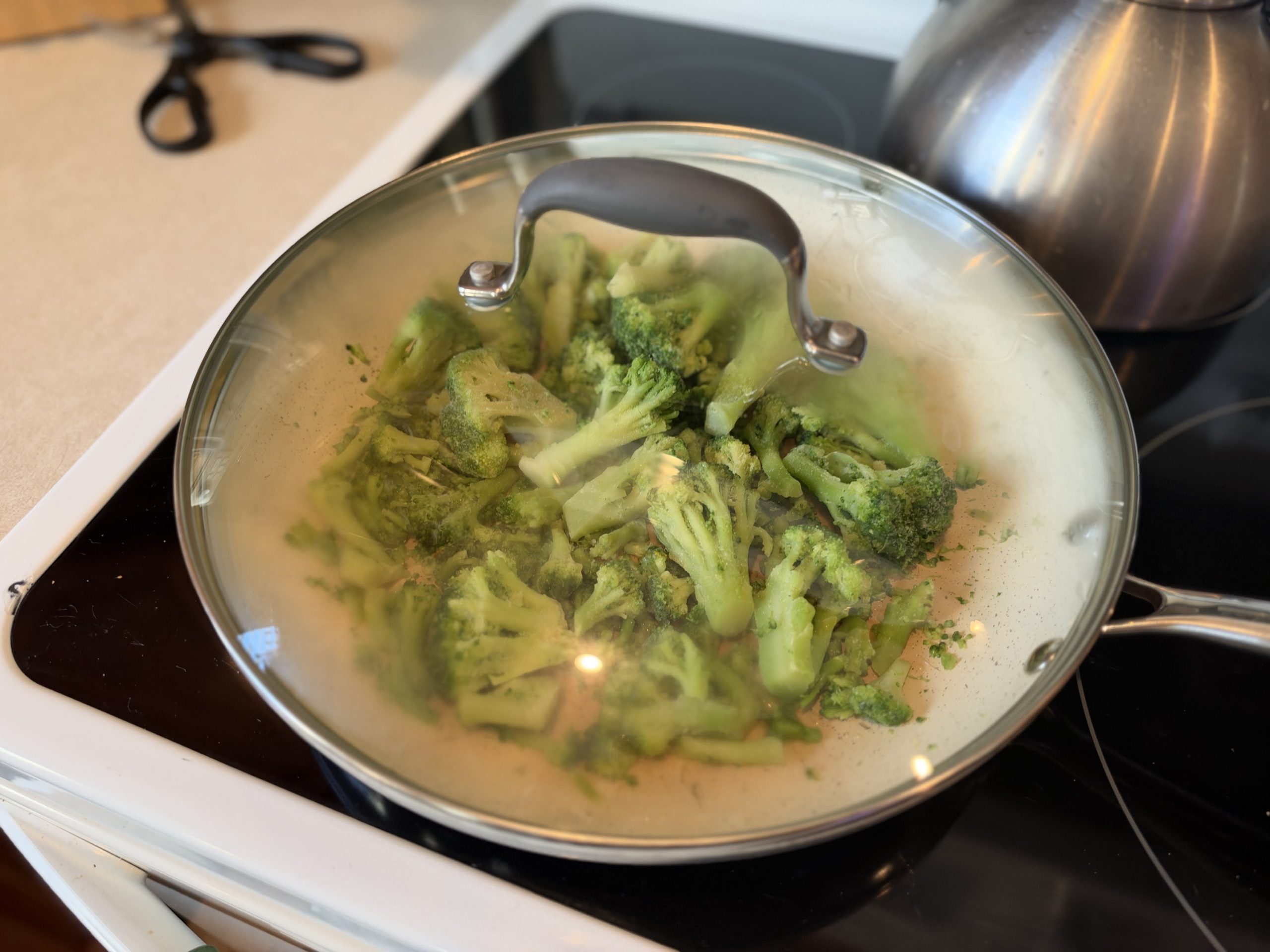 Broccoli steaming under a lid