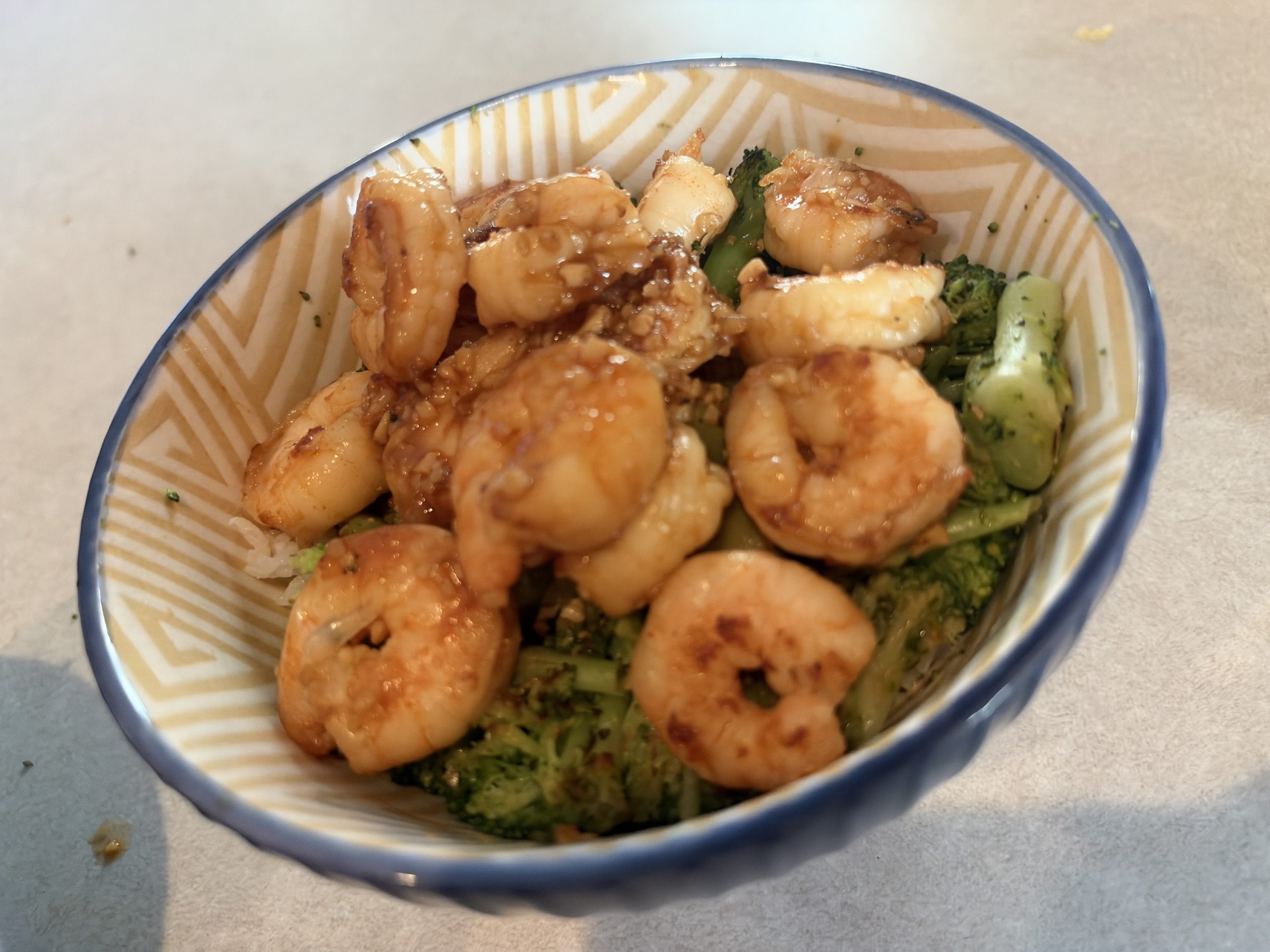 A shrimp and broccoli bowl coming together